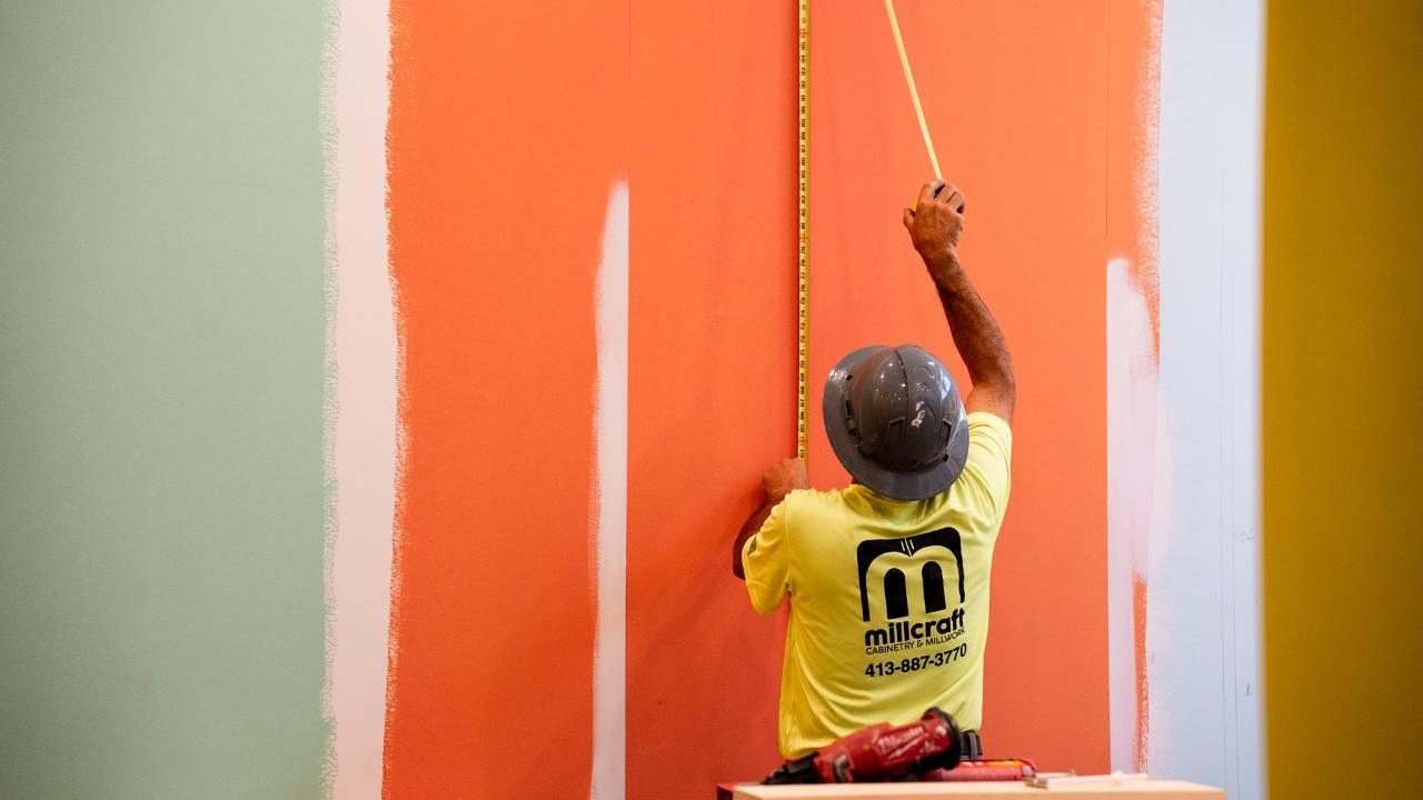 Millcraft team member measuring on a job site